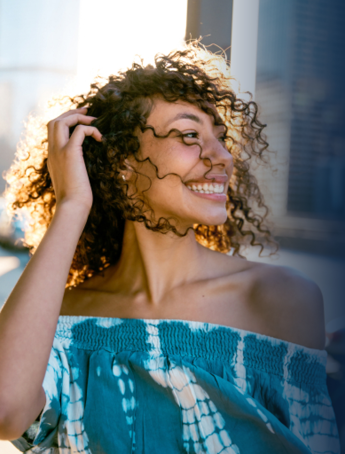 A woman smiling with the summer sunset behind her