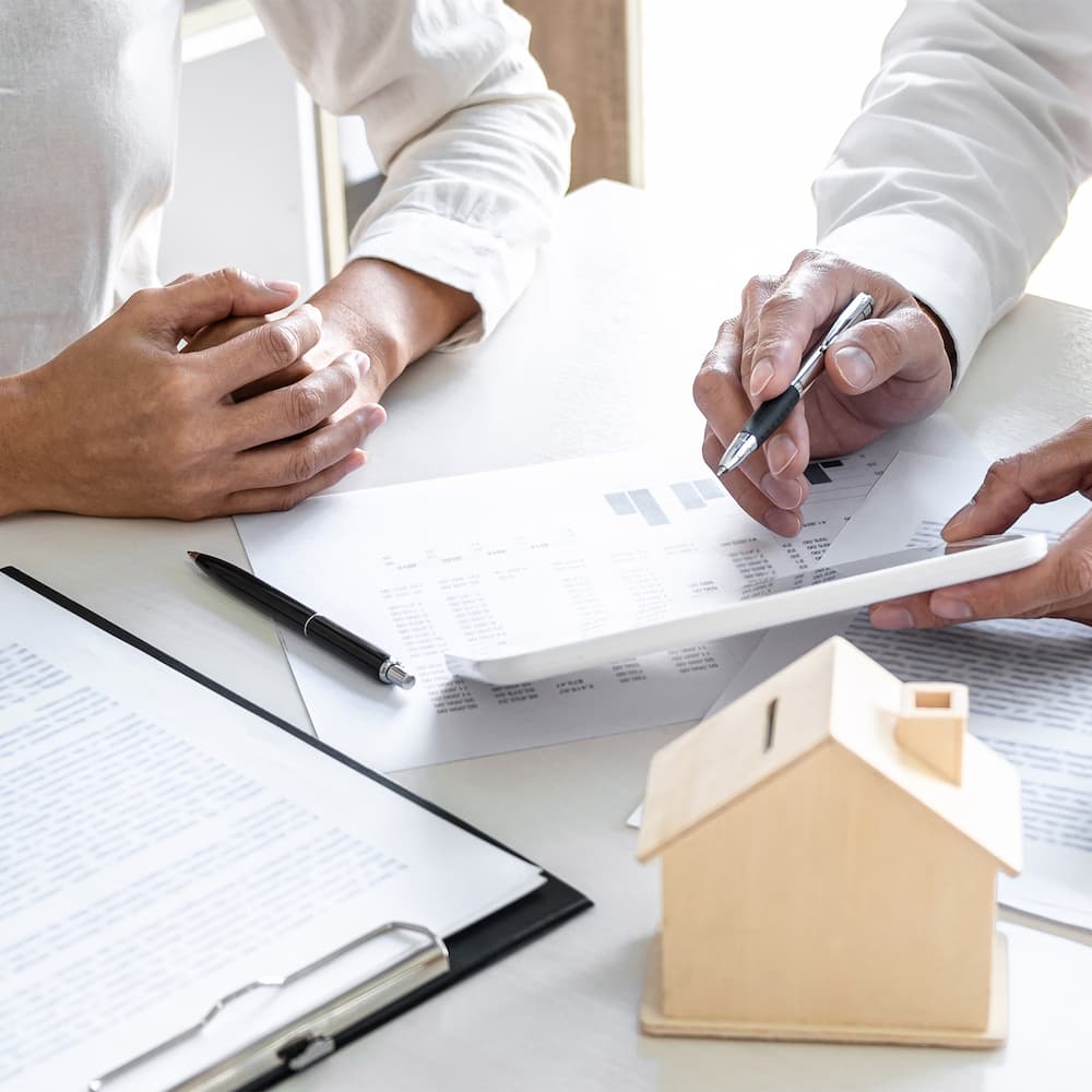 close-up view of two people reviewing financial documents